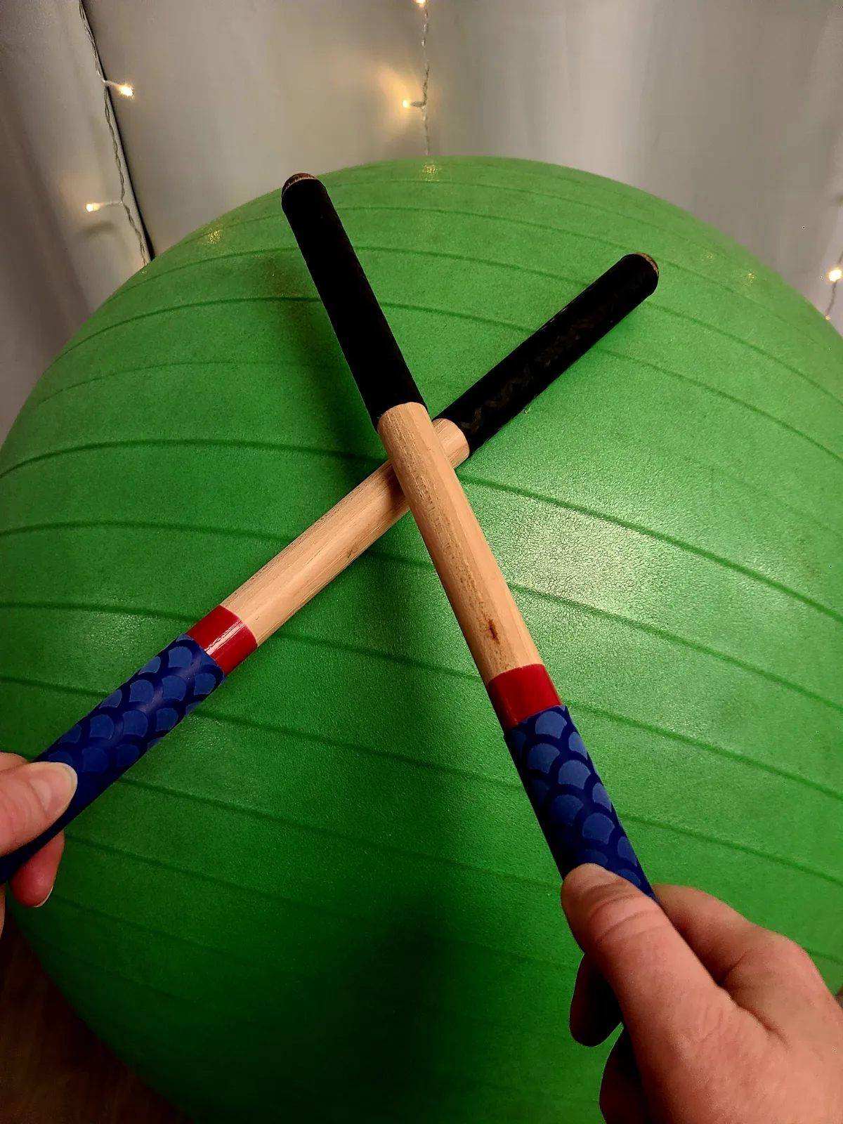 Close-up of drumsticks hitting a drum